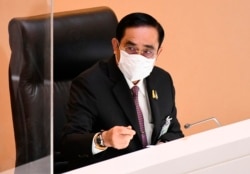 Thailand's Prime Minister Prayuth Chan-ocha arrives at the parliament in Bangkok, Thailand, Tuesday, Aug. 31, 2021.