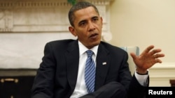 FILE - President Barack Obama answers questions during an interview in the Oval Office at the White House in Washington.