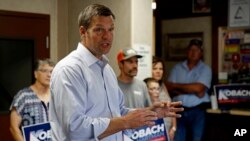 Kansas Secretary of State Kris Kobach and candidate for the Republican nomination for Kansas Governor addresses supporters during a campaign stop, Aug. 3, 2018, at the Fort Scott Livestock Market in Fort Scott, Kan.