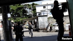 Policemen take up positions during an operation in Alemao slums complex, after violent clashes between policemen and drug dealers in Rio de Janeiro, Brazil May 4, 2017. 