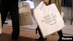 Attendees walk in the Congress Hall during the annual meeting of the World Economic Forum in Davos, Switzerland, Jan. 17, 2017.
