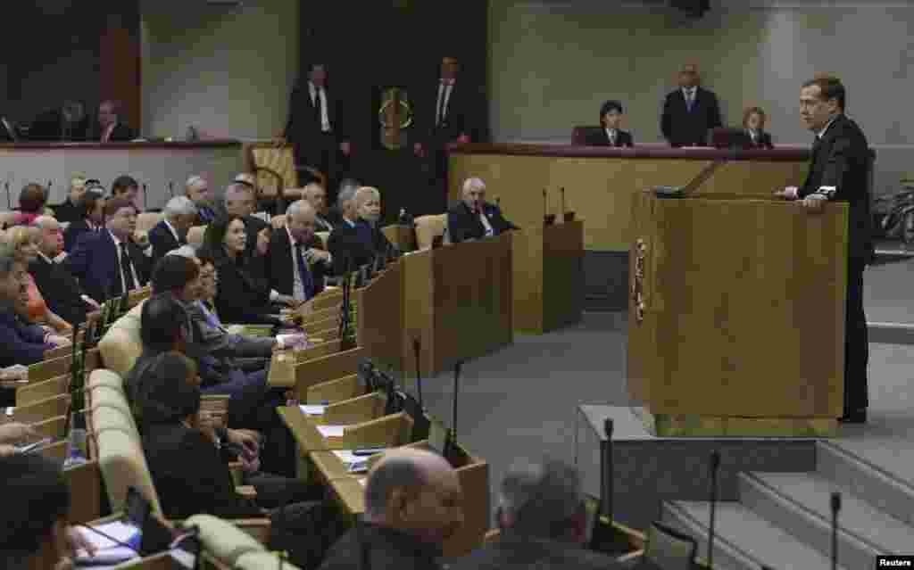 Russia's Prime Minister Dmitry Medvedev (right) addresses the State Duma, the lower house of parliament, saying that Russia is more interested than ever in diversifying destinations for its natural gas exports, Moscow, April 22, 2014.