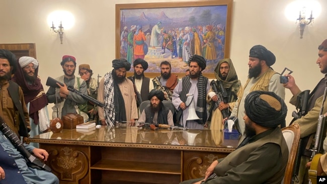 Taliban fighters take control of Afghan presidential palace after the Afghan President Ashraf Ghani fled the country, in Kabul, Afghanistan, Sunday, Aug. 15, 2021. (AP Photo/Zabi Karimi)