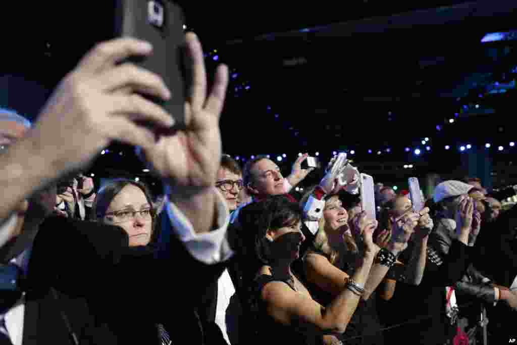 People take photos of President Donald Trump and first lady Melania Trump at the Freedom Ball, Jan. 20, 2017, in Washington. 