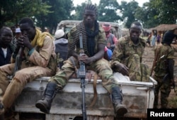FILE - Seleka fighters sit on a pick-up truck in the town of Goya, Central African Republic, June 11, 2014.