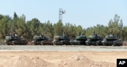 FILE - Turkish tanks stationed near the Syrian border, in Karkamis, Turkey, Saturday, Sept. 3, 2016. Turkey's state-run news agency says Turkish tanks have entered Syria's Cobanbey district northeast of Aleppo in a "new phase" of the Euphrates Shield operation.