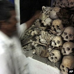 A Cambodian man stands in front of human bones and skulls of victims of the Khmer Rouge at a small shrine in Phnom Sampove, Battambang province, 314 kilometers (195 miles) northwest of Phnom Penh (file photo)