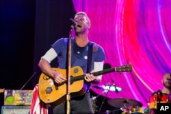 FILE - Chris Martin of Coldplay performs at The Budweiser Made In America Festival in Philadelphia.