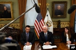 Vice President Mike Pence, center, sitting next to Carlos Anez, left, and Veronica Vadell Weggeman, right, speaks during a meeting in the Vice President's Ceremonial Office on the White House complex in Washington, with family members of the six Citgo executives currently detained in Venezuela, April 2, 2019.