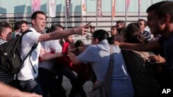 Turkish plainclothes police, left, push back protesters in Istanbul as they tried to stage a march to denounce the deaths in an explosion Monday in the Turkish town of Suruc near the Syrian border, July 21, 2015.