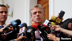 FILE - German ambassador to Venezuela Daniel Kriener speaks at a news conference flanked by Venezuelan opposition leader Juan Guaido, in Caracas, Venezuela, Feb. 19, 2019.