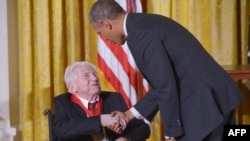 FILE - President Barack Obama presents the National Humanities Medal to literary critic M.H. Abrams during a ceremony in the East Room of the White House, in Washington, D.C., July 28, 2014.