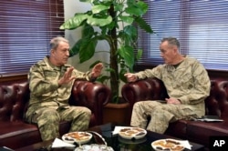 The U.S. chairman of the Joint Chiefs of Staff, Gen. Joseph Dunford, right, and Turkey's Chief of Staff Gen. Hulusi Akar talk during a meeting in Incirlik Airbase in Adana, Turkey, Feb. 17, 2017.