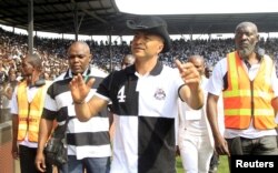 FILE - Moise Katumbi greets his supporters as he arrives to watch a soccer match in Lubumbashi, Oct. 4, 2015.