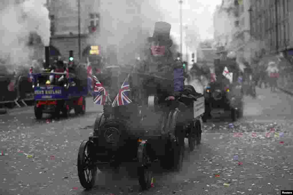 People ride model steam engines during the New Year&#39;s day parade in London, Britain.