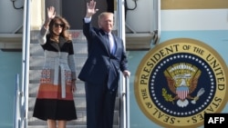 U.S. President Donald Trump and first lady Melania wave as they arrive at Yokota Air Base at Fussa in Tokyo, Nov. 5, 2017.