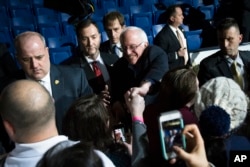 Democratic presidential candidate Sen. Bernie Sanders shakes hands with attendees during a campaign stop at the University of New Hampshire Whittemore Center Arena in Durham, N.H., Feb. 8, 2016.