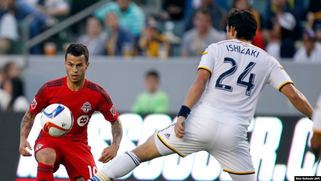 Los Angeles Galaxy midfielder Stefan Ishizaki (24) battles Toronto FC midfielder Sebastian Giovinco, left, for the ball during the first half of an MLS soccer game in Carson, Calif., Saturday, July 4, 2015. The Galaxy won 4-0.