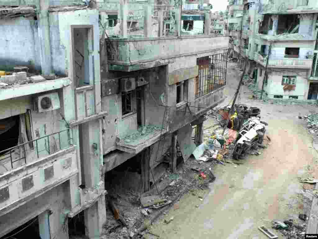 Damaged buildings along a street in the al-Khalidiya neighborhood of Homs, December 5, 2012. 