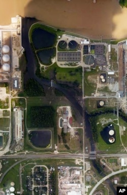 This aerial photo from the National Oceanic and Atmospheric Administration shows floodwaters surrounding the U.S. Oil Recovery Superfund site outside Houston flowing into the San Jacinto River. The Environmental Protection Agency says it has found no evidence toxic waste washed off the site.