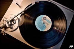 An old vinyl record album on a turntable.