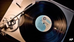 An old vinyl record album on a turntable