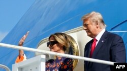 Outgoing US President Donald Trump and US First Lady Melania Trump arrive at Palm Beach International Airport in West Palm Beach, Florida, on January 20, 2021.