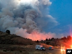 This photo provided by the Department of Homeland Security Emergency Management shows a wildfire burning near Forbes Park in southern Colorado, June 28, 2018.