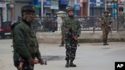 Indian paramilitary soldiers stand guard in a closed market in Srinagar, Indian-controlled Kashmir, Feb. 23, 2019.