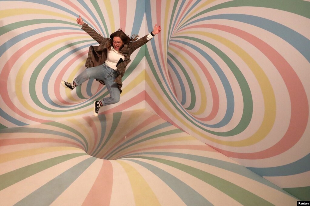 A girl poses for a photo during a visit to the Instagram museum