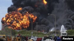 A fire burned for a third day in two fuel storage tanks at Venezuela's biggest refinery, August 27, 2012.