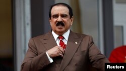 FILE - Bahrain's King Hamad bin Isa Al Khalifa is pictured in Windsor, England, May 11, 2018. In addition to charges filed against alleged militants on Sept. 25, 2018, Bahrain's Interior Ministry separately said police had arrested 15 people over "Iran-backed'' vandalism — most likely a reference to people spray-painting "Down with Hamad'' on roadways recently.
