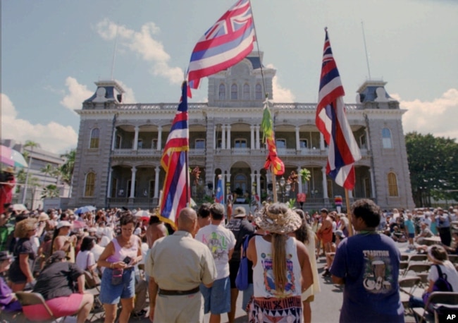 Hawaiians who marched from the Royal Mausoleum in Nuuanu arrived at Iolani Palace Wednesday Aug. 12, 1998 to begin a somber commemoration of the 100th anniversary of the annexation of Hawaii by the United States in Honolulu, Hawaii.