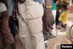 FILE - A member of the of an Anti-Balaka armed militia displays his weapon in the town of of Bocaranga, Central African Republic, April 28, 2017.