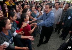 Cambodia's Prime Minister Hun Sen greets garment workers during a visit to the Phnom Penh Special Economic Zone on the outskirts of Phnom Penh, Cambodia, Aug. 23, 2017.