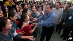 Cambodia's Prime Minister Hun Sen greets garment workers during a visit to the Phnom Penh Special Economic Zone on the outskirts of Phnom Penh, Cambodia, Aug. 23, 2017. The U.S. State Department expressed concern Wednesday about what it said it was the d