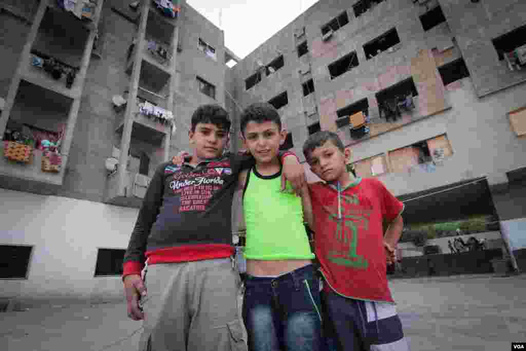 Syrian youngsters pose in front of the Ouzai building. With some families here for more than three years, many have grown up here. (Photo - J. Owens/VOA)