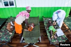 FILE - Sick children are treated by health workers at a hospital in Agats, Asmat District, after the government dispatched military and medical personnel to the remote region of Papua to combat malnutrition and measles, Jan. 22, 2018.