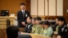 Sewol ferry captain Lee Joon-seok (3rd R) sits with crew members at the start of the verdict proceedings in a court room in Gwangju, November 11, 2014.