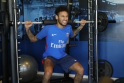 FILE - Brazil's football player Neymar works out in the gym on weight training machines at the Paris Saint-Germain training center, Paris, May 5, 2018. (Twitter / PSG)