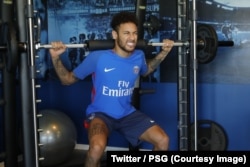 FILE - Brazil's football player Neymar works out in the gym on weight training machines at the Paris Saint-Germain training center, Paris, May 5, 2018. (Twitter / PSG)