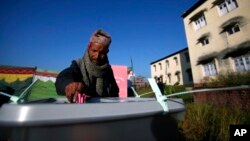 A Nepalese voter casts his vote at a polling station in Bhaktapur, Nepal, Tuesday, Nov. 19, 2013.