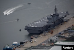 FILE - Japan Maritime Self-Defense Force's (JMSDF) latest Izumo-class helicopter carrier DDH-184 Kaga is moored at a naval base in Sasebo, on the southwest island of Kyushu, Japan April 6, 2018.