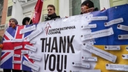 Activists hold a poster to thank the British government for support during a rally at the British embassy in Kyiv, Ukraine, Friday, Jan. 21, 2022. The UK sent 30 elite troops and 2,000 anti-tank weapons to Ukraine amid fears of Russian invasion.
