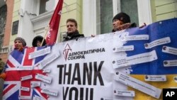 Activists hold a poster to thank the British government for support during a rally at the British Embassy in Kyiv, Ukraine, Jan. 21, 2022. The UK sent 30 elite troops and 2,000 anti-tank weapons to Ukraine amid fears of Russian invasion.