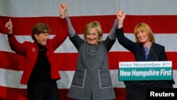 Former United States Secretary of State Hillary Clinton, center, joins U.S. Senator Jeanne Shaheen, a New Hampshire Democrat, left, and New Hampshire Governor Maggie Hassan at a re-election campaign rally in Nashua, New Hampshire, Nov. 2, 2014. 