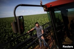 Arnaldo Zunizakae, who manages farming on the vast Pareci reservation, poses for a photograph in a corn field near the town of Campo Novo do Parecis, Brazil, April 26, 2018.