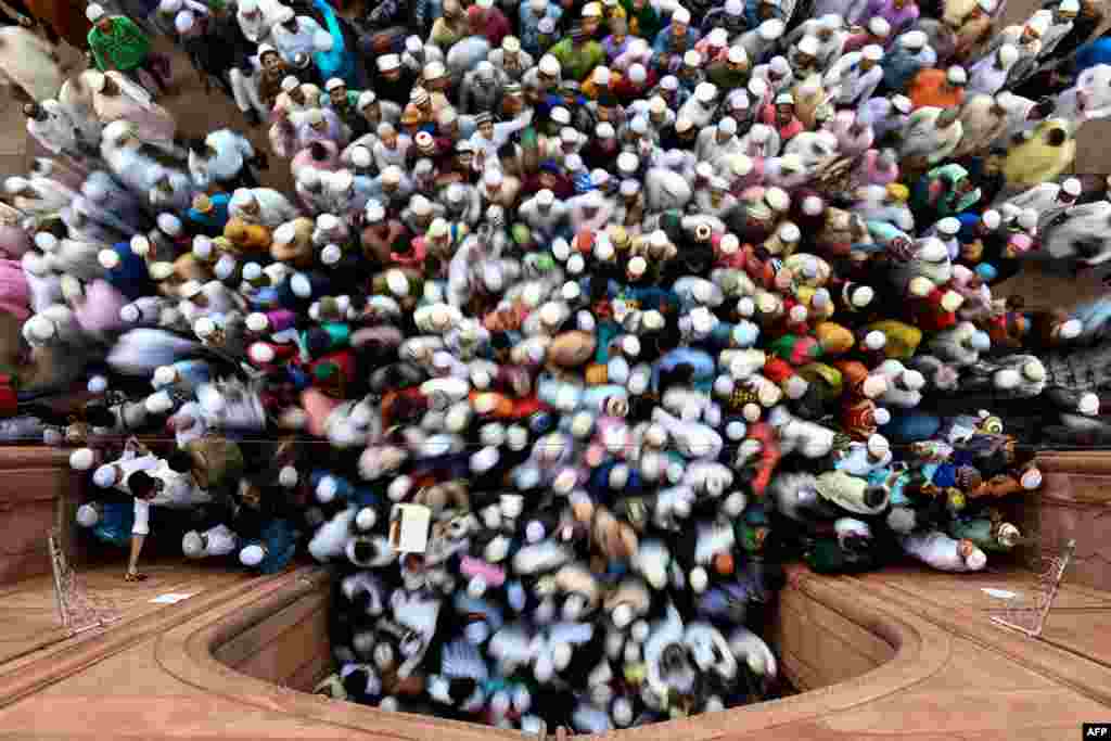 Indian Muslims leave after offering Eid al-Adha prayers at the Jama Masjid mosque in New Delhi.