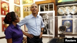 President Barack Obama gets tour of the Bob Marley Museum from staff member Natasha Clark, Kingston, Jamaica, April 8, 2015.