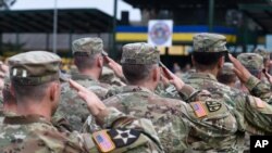 FILE - U.S. soldiers salute during international military exercises at training grounds outside Lviv, Ukraine, Sept. 3, 2018.